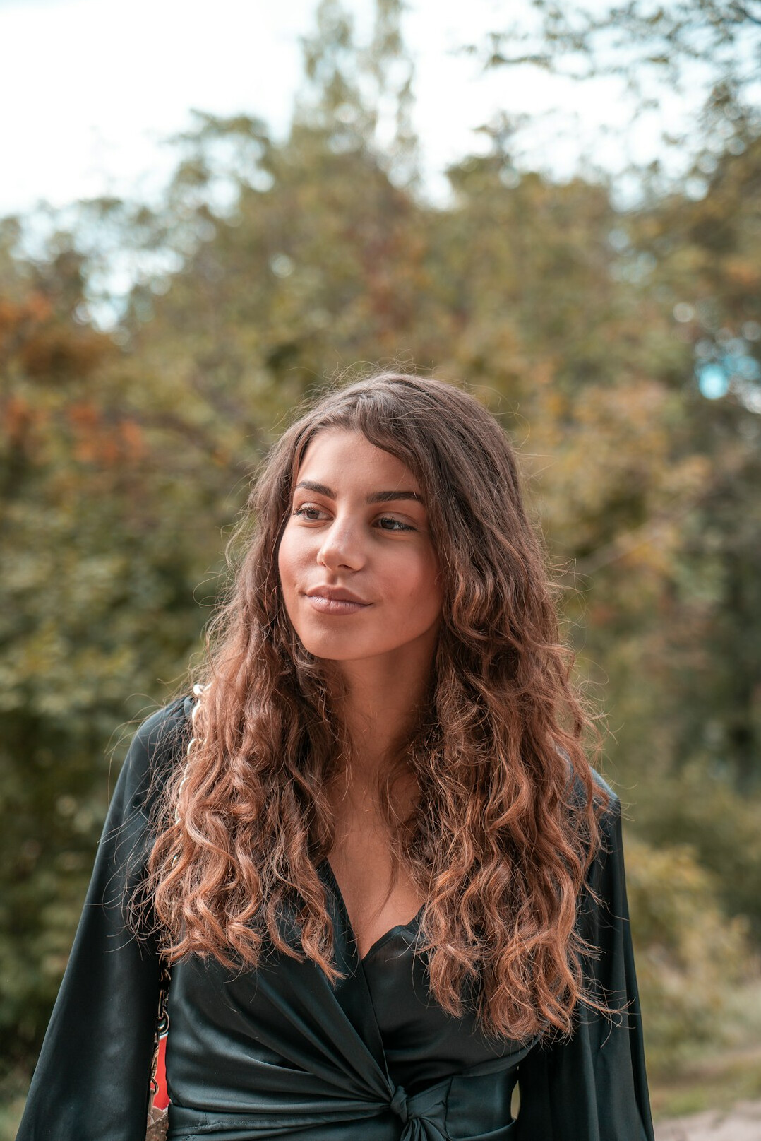 Portrait of a smiling young woman with curly hair